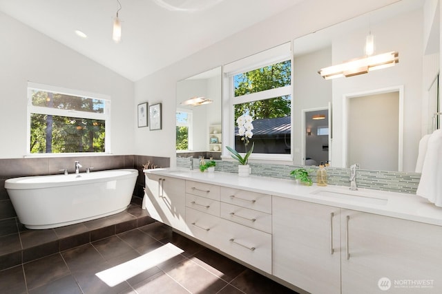 21955 SE 30th Pl, Sammamish, WA 98075 - full bath featuring double vanity, healthy amount of natural light, a freestanding bath, tile patterned flooring, and wainscoting