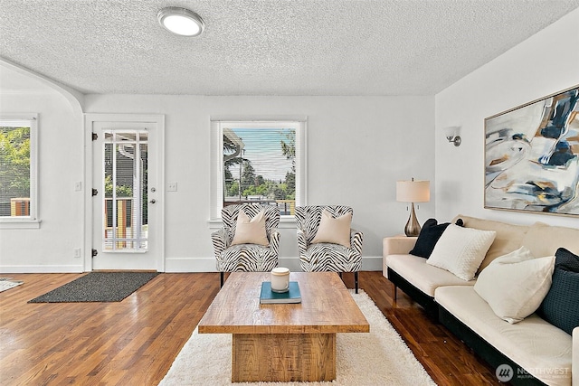 9819 Park Ave S, Tacoma, WA 98444 - living room with wood finished floors, a textured ceiling, and baseboards