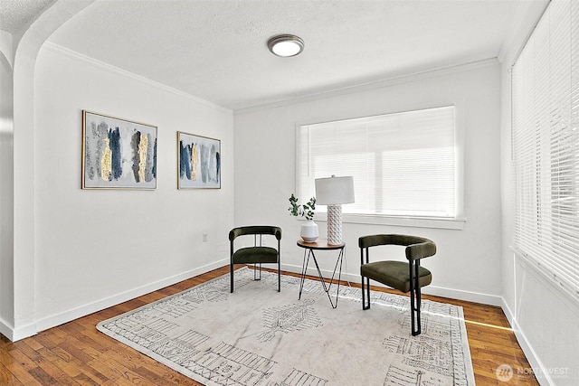9819 Park Ave S, Tacoma, WA 98444 - sitting room with ornamental molding, wood finished floors, arched walkways, a textured ceiling, and baseboards