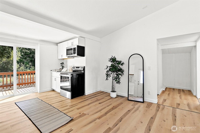 9819 Park Ave S, Tacoma, WA 98444 - kitchen with stainless steel appliances, light wood-type flooring, white cabinets, and baseboards
