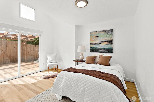 9819 Park Ave S, Tacoma, WA 98444 - bedroom with access to exterior, wood finished floors, and baseboards