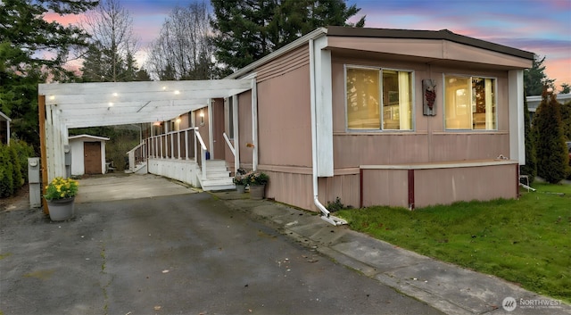 2101 S 324th St Unit 9, Federal Way, WA 98003 - view of front of house featuring an outbuilding, a carport, and driveway