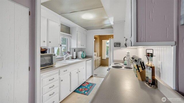 2101 S 324th St Unit 9, Federal Way, WA 98003 - kitchen with a sink, dishwasher, light countertops, white cabinets, and healthy amount of natural light