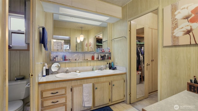 2101 S 324th St Unit 9, Federal Way, WA 98003 - full bathroom with toilet, double vanity, a walk in closet, and tile patterned flooring