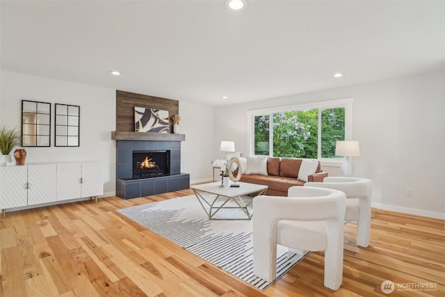 429 217th Pl SW, Bothell, WA 98021 - living area with wood finished floors, a tile fireplace, baseboards, and recessed lighting