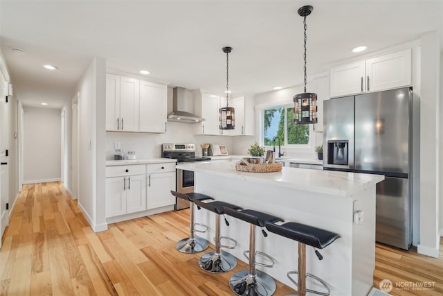429 217th Pl SW, Bothell, WA 98021 - kitchen featuring appliances with stainless steel finishes, wall chimney exhaust hood, light countertops, white cabinets, and recessed lighting