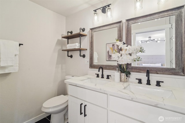 429 217th Pl SW, Bothell, WA 98021 - bathroom featuring toilet, double vanity, and baseboards