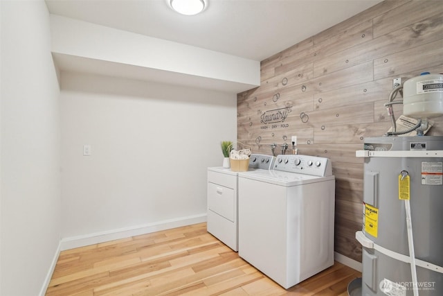 429 217th Pl SW, Bothell, WA 98021 - laundry area featuring washing machine and dryer, secured water heater, wood finished floors, and baseboards