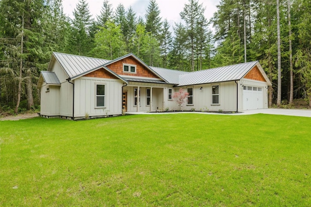2075 NW Peterson Rd, Poulsbo, WA 98370 - view of front of property featuring board and batten siding, a front yard, a standing seam roof, concrete driveway, and metal roof