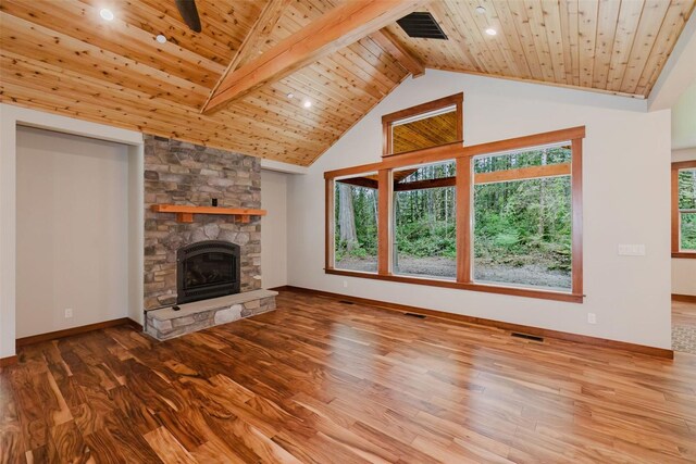 2075 NW Peterson Rd, Poulsbo, WA 98370 - unfurnished living room with wood finished floors, wooden ceiling, healthy amount of natural light, a stone fireplace, and beam ceiling
