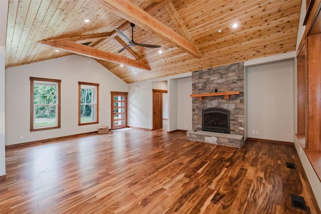 2075 NW Peterson Rd, Poulsbo, WA 98370 - unfurnished living room with wood ceiling, wood finished floors, a stone fireplace, a ceiling fan, and baseboards
