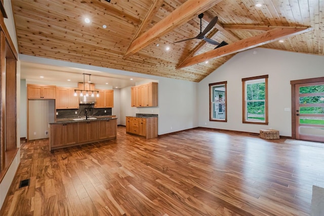 2075 NW Peterson Rd, Poulsbo, WA 98370 - unfurnished living room featuring wood ceiling, light wood-type flooring, beamed ceiling, a ceiling fan, and recessed lighting
