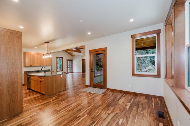 2075 NW Peterson Rd, Poulsbo, WA 98370 - kitchen featuring open floor plan, stainless steel dishwasher, lofted ceiling, light wood finished floors, and a sink