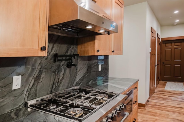 2075 NW Peterson Rd, Poulsbo, WA 98370 - kitchen with exhaust hood, tasteful backsplash, stovetop, light brown cabinets, and recessed lighting