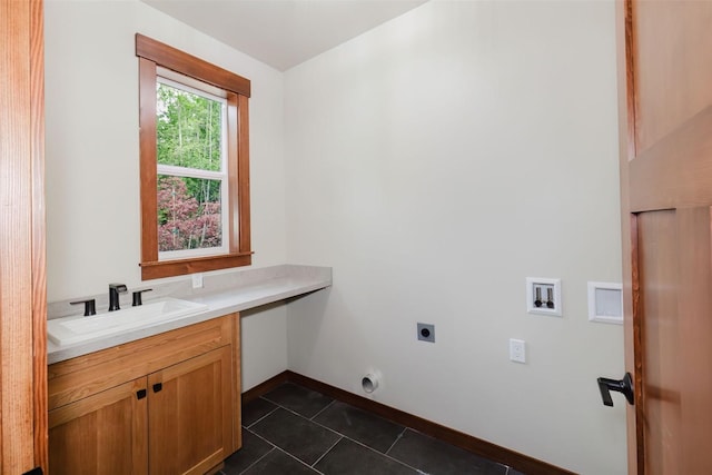 2075 NW Peterson Rd, Poulsbo, WA 98370 - clothes washing area featuring electric dryer hookup, baseboards, dark tile patterned floors, cabinet space, and washer hookup
