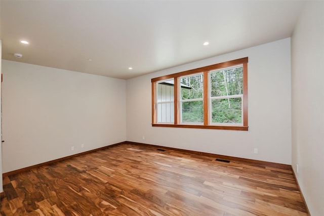 2075 NW Peterson Rd, Poulsbo, WA 98370 - unfurnished room with wood finished floors, baseboards, and recessed lighting