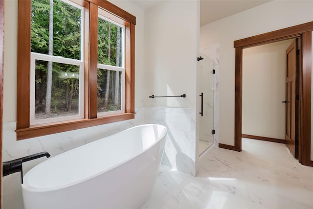 2075 NW Peterson Rd, Poulsbo, WA 98370 - full bathroom featuring a stall shower, a freestanding tub, marble finish flooring, and wainscoting