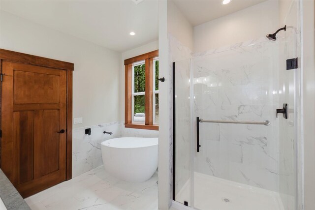 2075 NW Peterson Rd, Poulsbo, WA 98370 - full bath featuring a marble finish shower, tile walls, a freestanding bath, a wainscoted wall, and recessed lighting