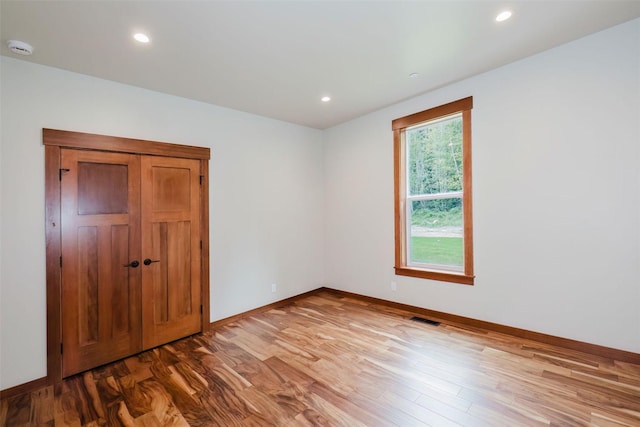 2075 NW Peterson Rd, Poulsbo, WA 98370 - empty room with wood finished floors, a smoke detector, baseboards, and recessed lighting