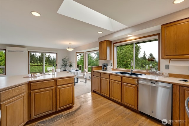 kitchen featuring dishwasher, a sink, a wall mounted AC, light countertops, and recessed lighting