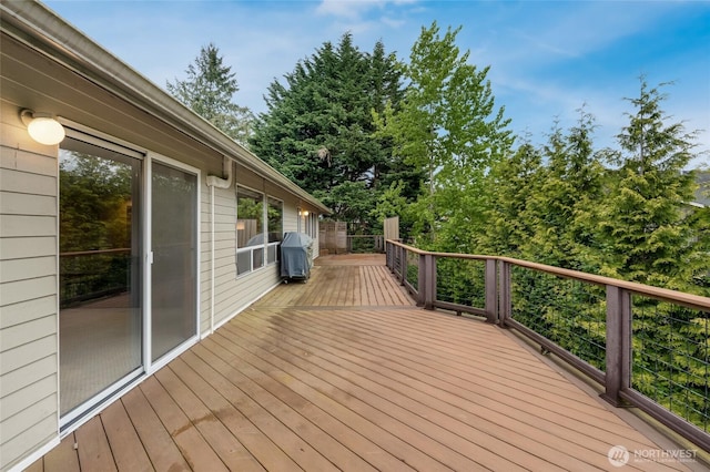 wooden deck featuring area for grilling