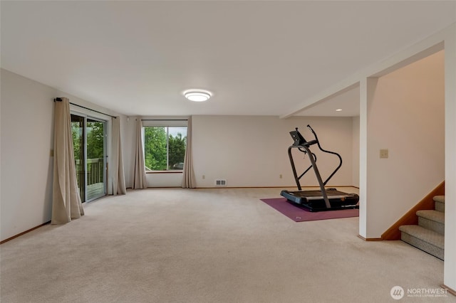 workout area with light colored carpet and baseboards