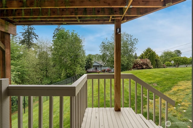 wooden terrace featuring a yard