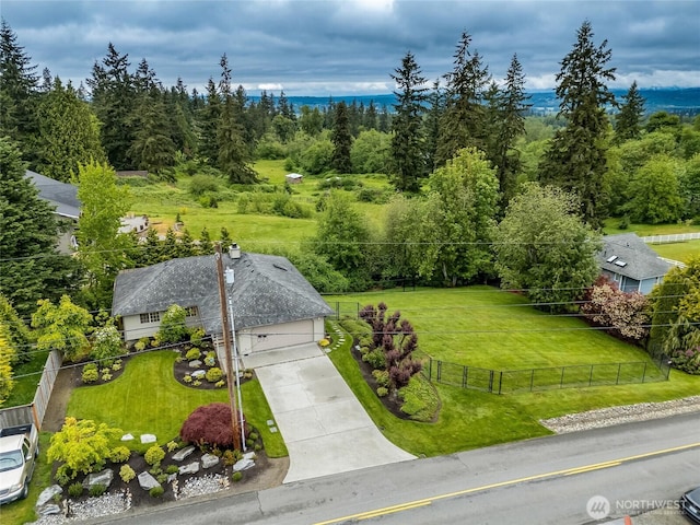 aerial view of property and surrounding area with a heavily wooded area