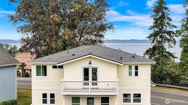 691 N W Camano Dr, Camano Island, WA 98282 - rear view of property with a balcony, a water and mountain view, french doors, and roof with shingles