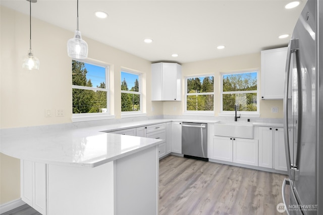 691 N W Camano Dr, Camano Island, WA 98282 - kitchen featuring appliances with stainless steel finishes, a sink, a peninsula, healthy amount of natural light, and recessed lighting