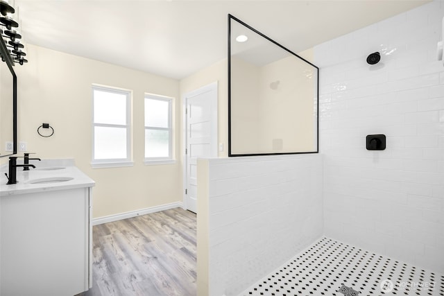691 N W Camano Dr, Camano Island, WA 98282 - bathroom featuring tiled shower, double vanity, wood finished floors, and baseboards