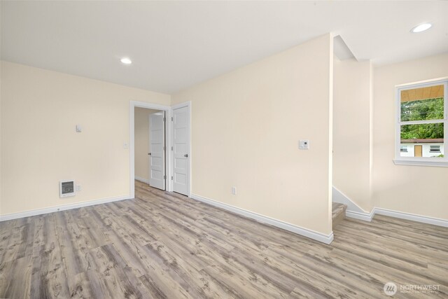 691 N W Camano Dr, Camano Island, WA 98282 - spare room featuring wood finished floors, baseboards, recessed lighting, and stairs