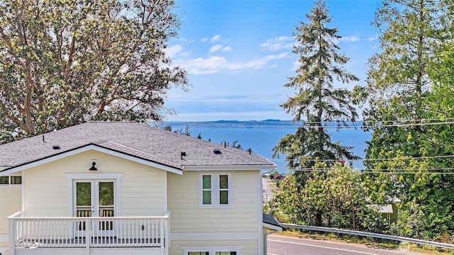 691 N W Camano Dr, Camano Island, WA 98282 - rear view of property with a shingled roof and a water view