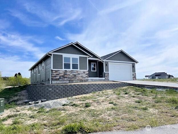 9 Columbia View Dr, Brewster, WA 98812 - craftsman-style house featuring concrete driveway, an attached garage, and stone siding