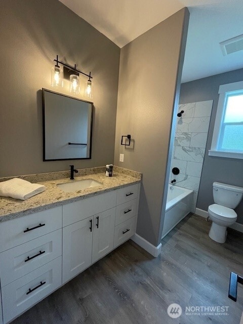 9 Columbia View Dr, Brewster, WA 98812 - bathroom with wood finished floors, baseboards, toilet, vanity, and  shower combination