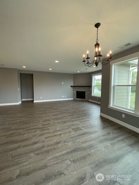 9 Columbia View Dr, Brewster, WA 98812 - unfurnished living room with a chandelier, baseboards, dark wood-style flooring, recessed lighting, and a fireplace