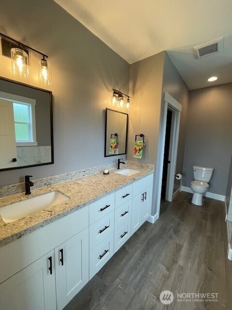 9 Columbia View Dr, Brewster, WA 98812 - bathroom with toilet, wood finished floors, double vanity, and baseboards