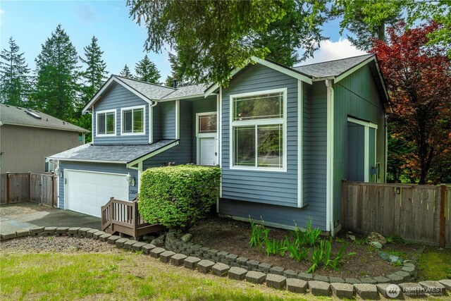 13014 97th Ave NW, Gig Harbor, WA 98329 - view of front of house featuring fence, a garage, roof with shingles, and driveway