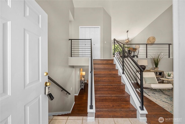 13014 97th Ave NW, Gig Harbor, WA 98329 - stairway featuring a chandelier, tile patterned flooring, and baseboards