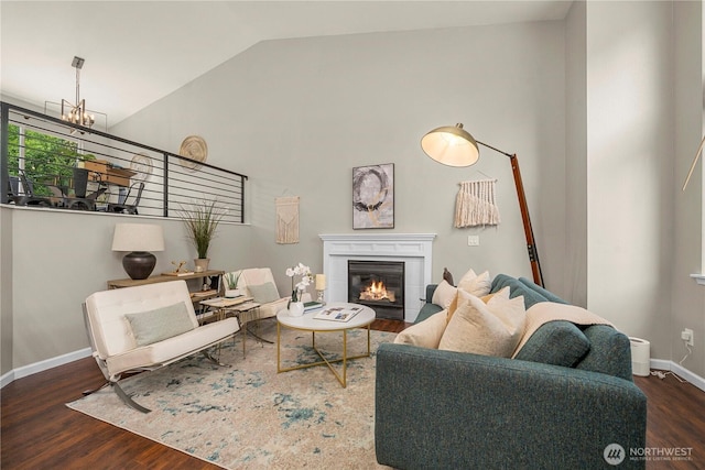 13014 97th Ave NW, Gig Harbor, WA 98329 - living room with wood finished floors, vaulted ceiling, a glass covered fireplace, and baseboards