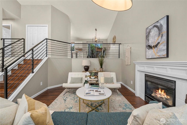 13014 97th Ave NW, Gig Harbor, WA 98329 - living room with wood finished floors, baseboards, a tiled fireplace, and high vaulted ceiling