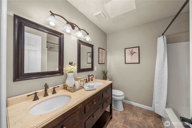 13014 97th Ave NW, Gig Harbor, WA 98329 - bathroom featuring toilet, a shower with shower curtain, double vanity, baseboards, and stone finish floors
