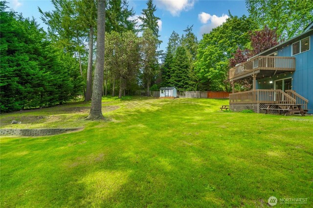 13014 97th Ave NW, Gig Harbor, WA 98329 - view of grassy yard with a wooden deck, a storage unit, and an outdoor structure