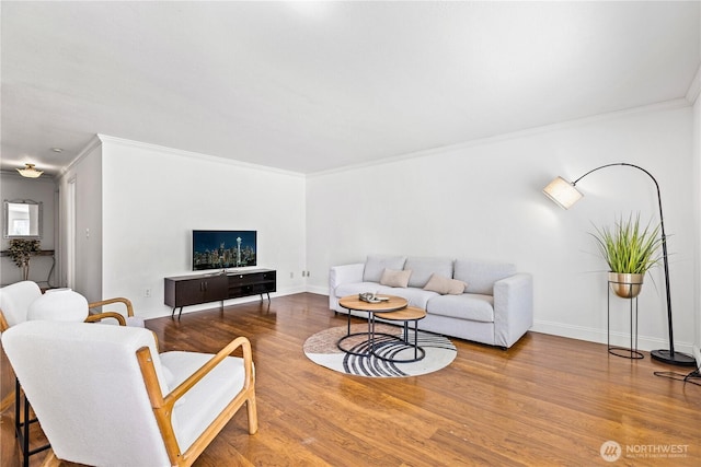 living area featuring wood finished floors, ornamental molding, and baseboards
