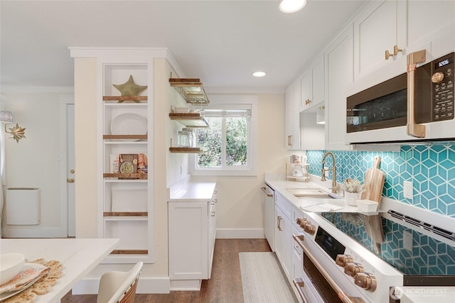 kitchen with electric range, a sink, white cabinets, dark wood-type flooring, and dishwasher
