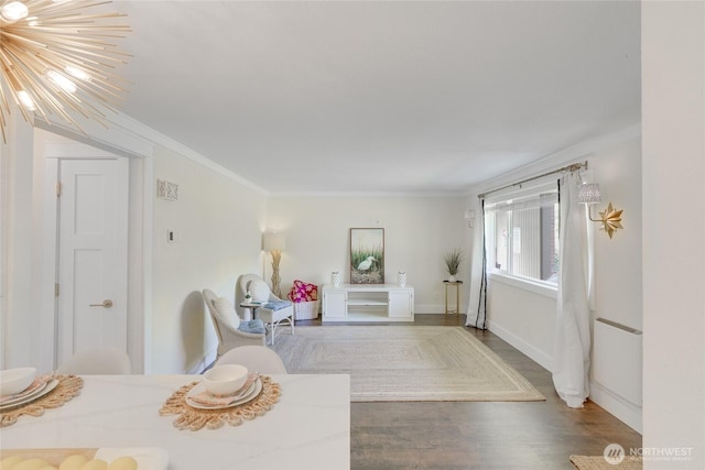 bedroom featuring crown molding, wood finished floors, and baseboards