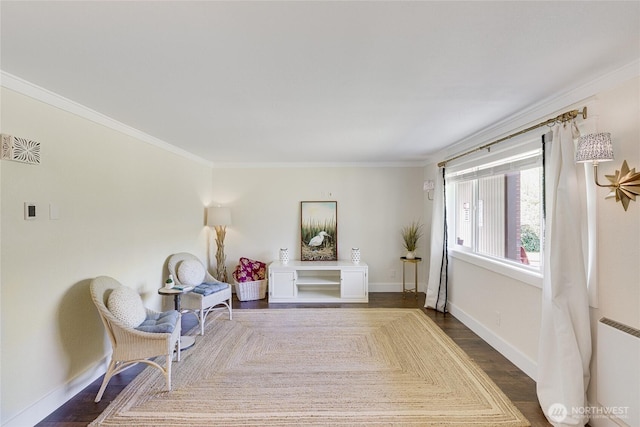 living area with ornamental molding, dark wood finished floors, baseboards, and radiator