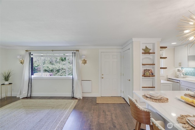 dining space with dark wood-type flooring and baseboards