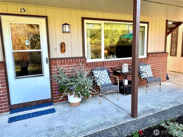 doorway to property with brick siding