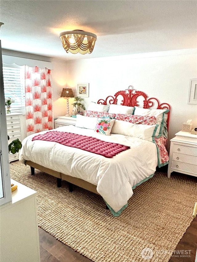 bedroom with dark wood-type flooring and a textured ceiling